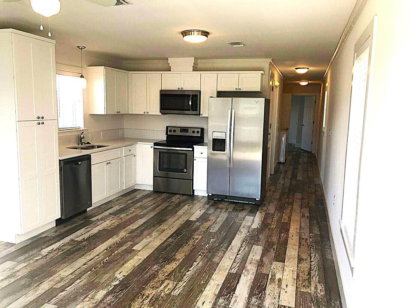 53 Rosin Cup Circle Santa Rosa Beach, FL 32459 - Photo 7 of 22 a kitchen with stainless steel appliances granite countertop a refrigerator a stove top oven a sink and dishwasher