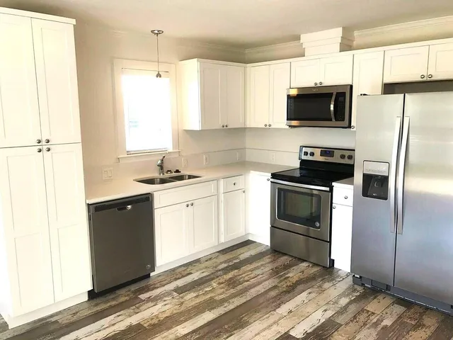 a kitchen with a sink stove and microwave