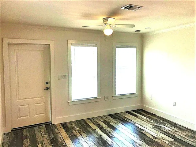 a view of a room with wooden floor