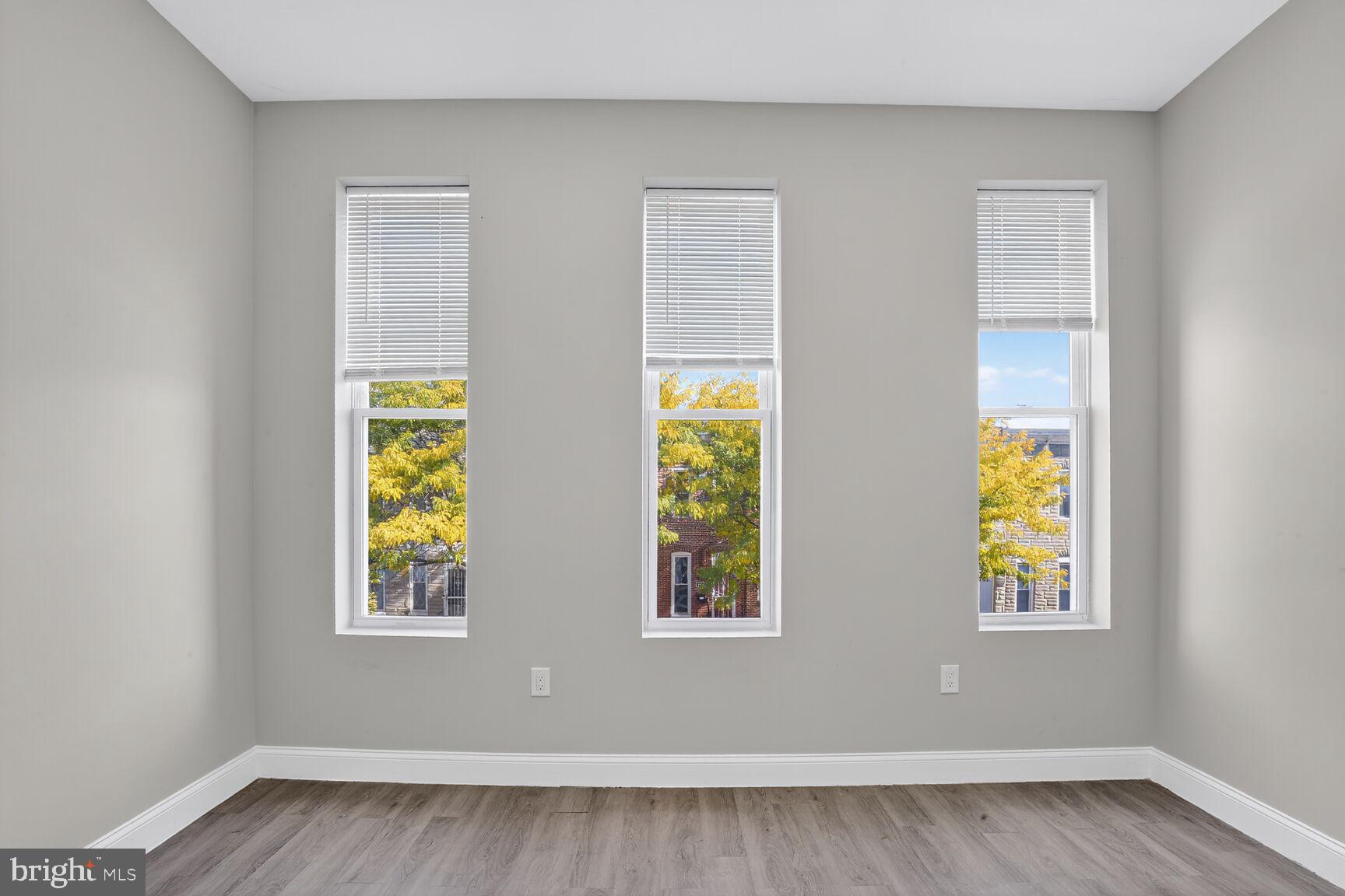 1106 South Carey Street Baltimore, MD 21223 - Photo 12 of 24 wooden floor in an empty room with a window