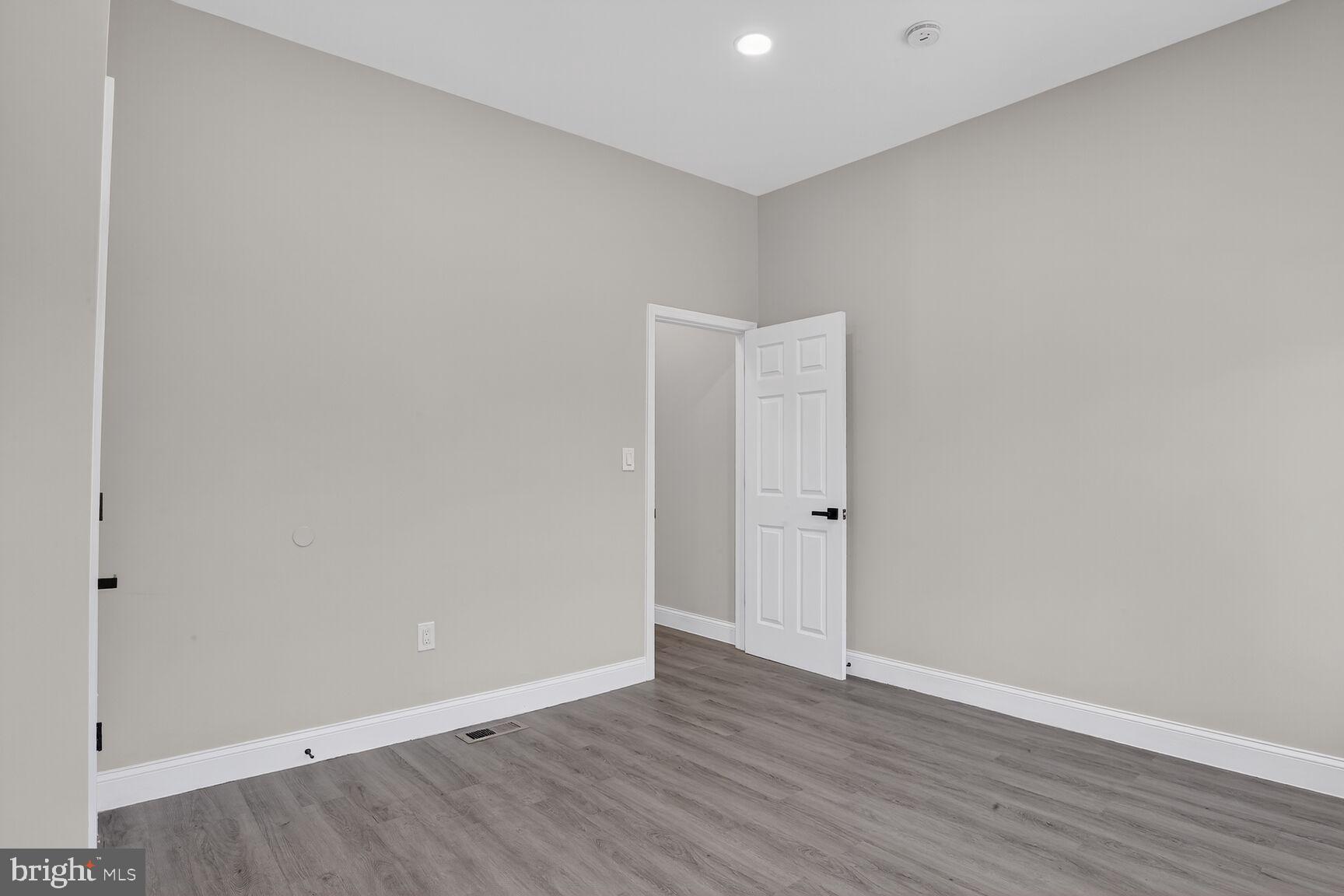 1106 South Carey Street Baltimore, MD 21223 - Photo 13 of 24 a view of an empty room with wooden floor