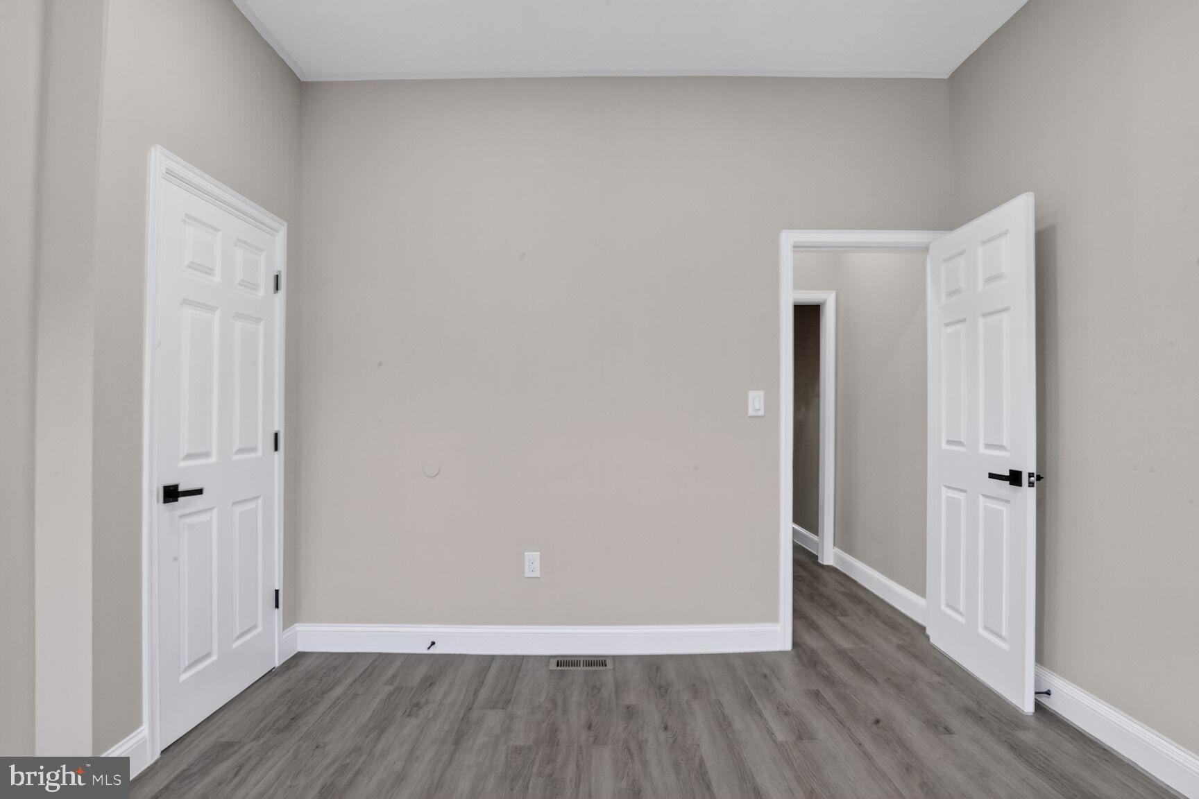 1106 South Carey Street Baltimore, MD 21223 - Photo 14 of 24 a view of a hallway with wooden floor