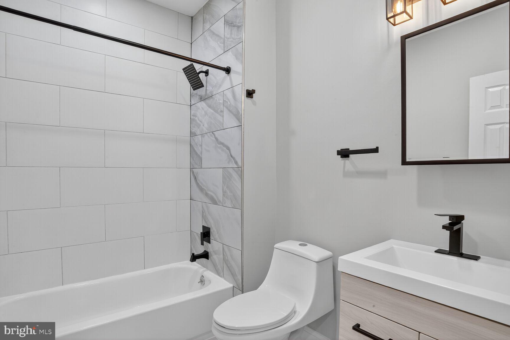 1106 South Carey Street Baltimore, MD 21223 - Photo 15 of 24 a bathroom with a sink a toilet and a bathtub