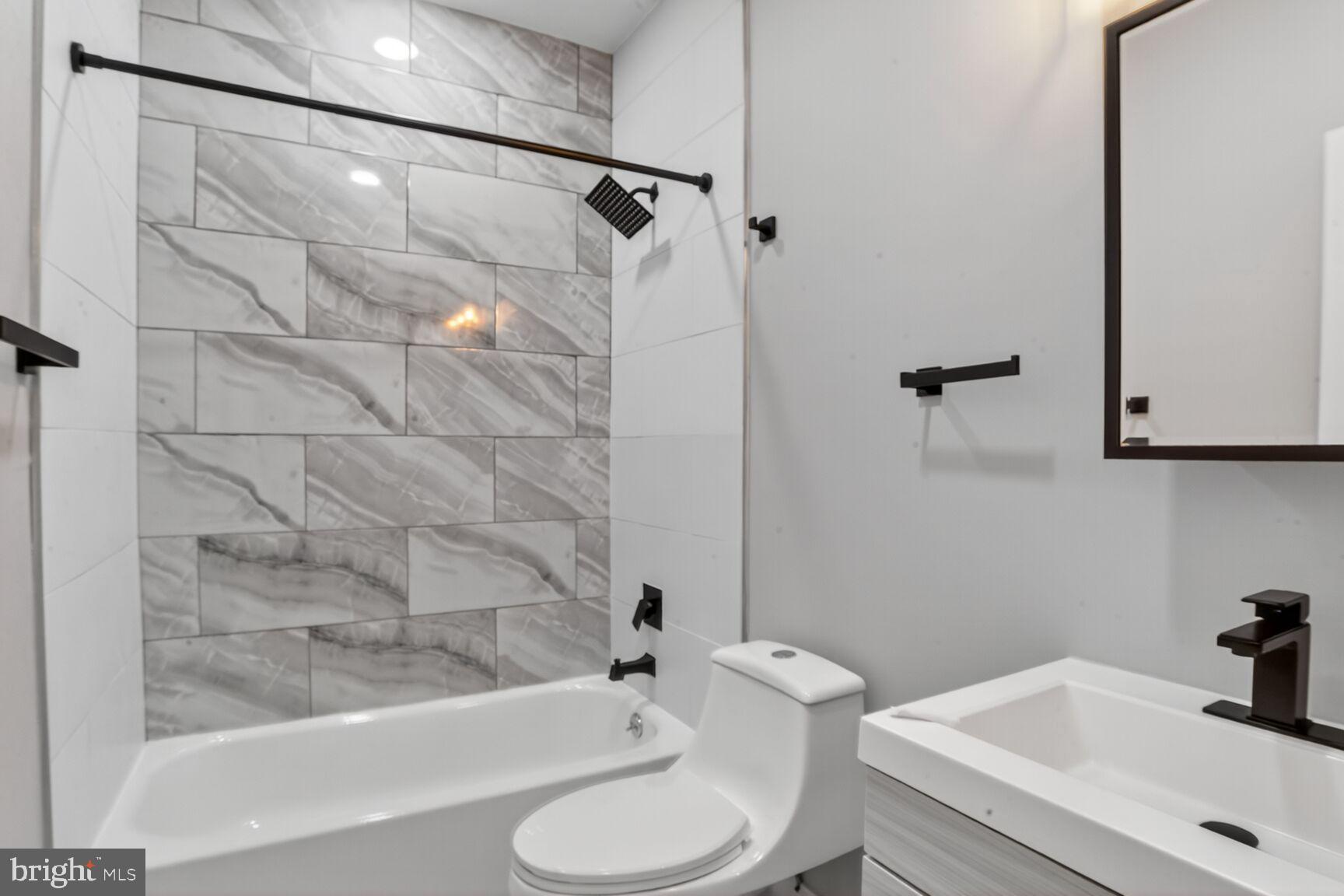 1106 South Carey Street Baltimore, MD 21223 - Photo 16 of 24 a bathroom with a sink toilet and shower