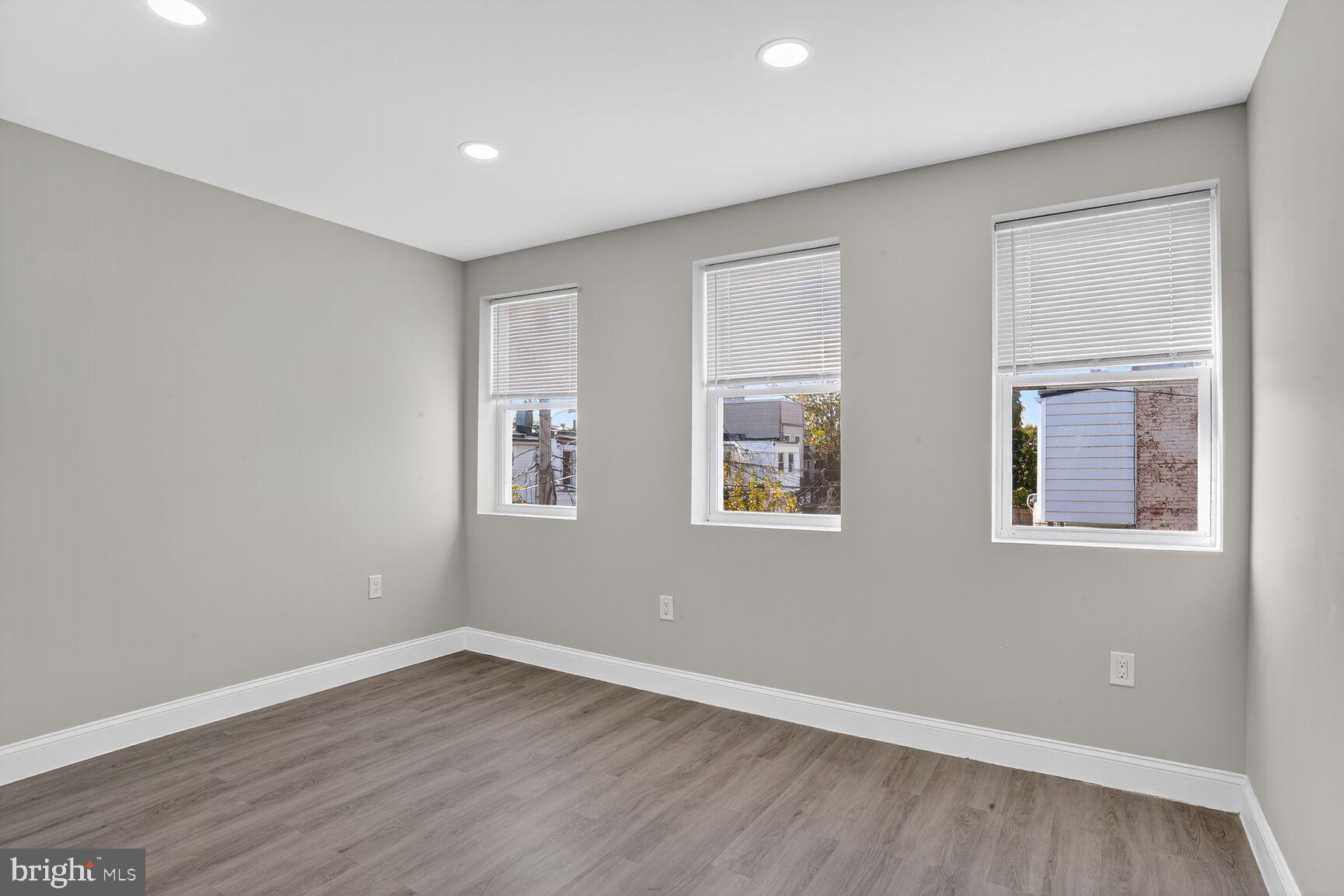 1106 South Carey Street Baltimore, MD 21223 - Photo 17 of 24 a view of empty room with wooden floor and fan