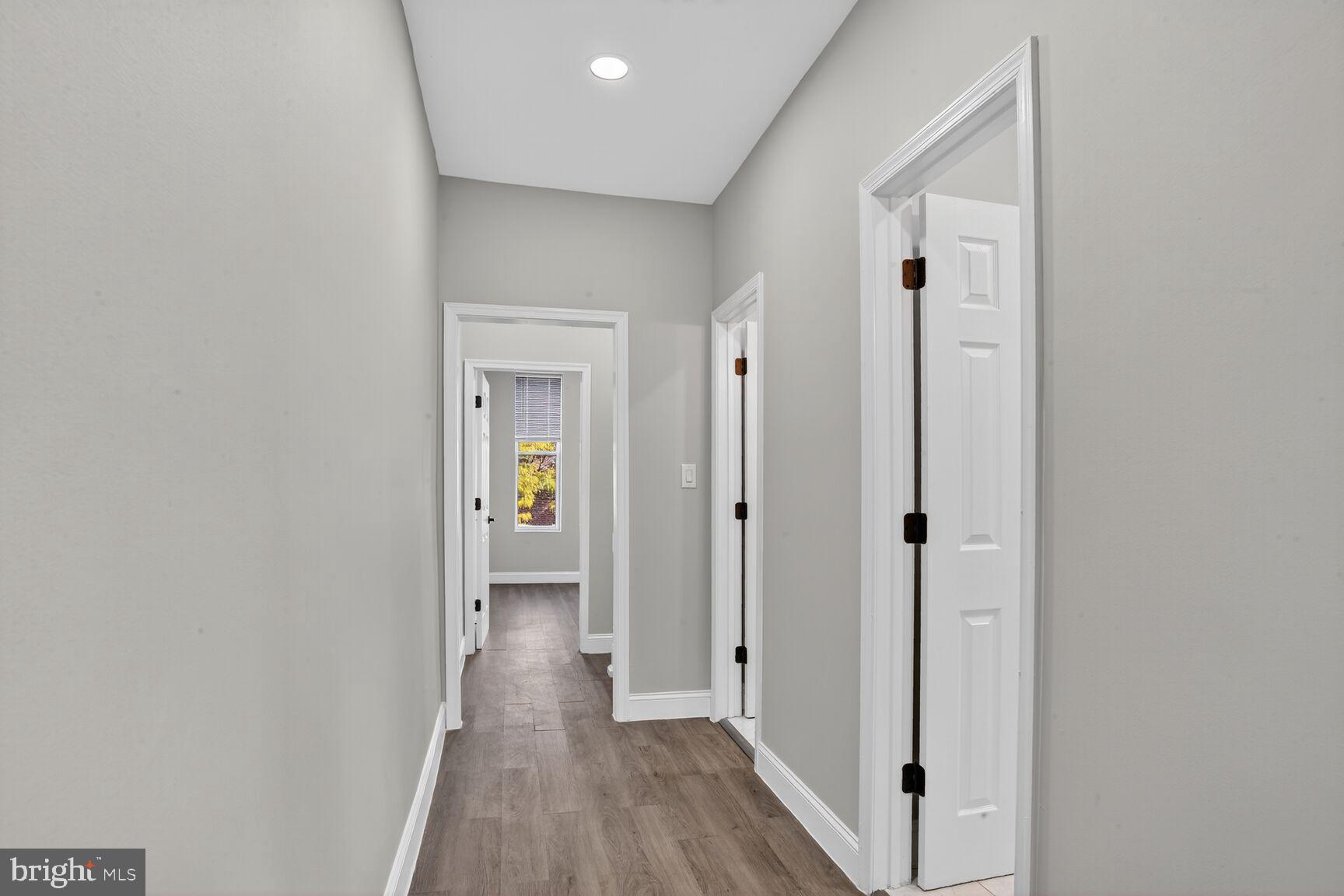 1106 South Carey Street Baltimore, MD 21223 - Photo 19 of 24 a view of hallway with wooden floor