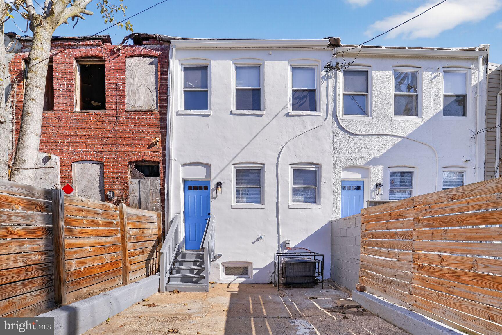 1106 South Carey Street Baltimore, MD 21223 - Photo 20 of 24 a front view of a building with many windows