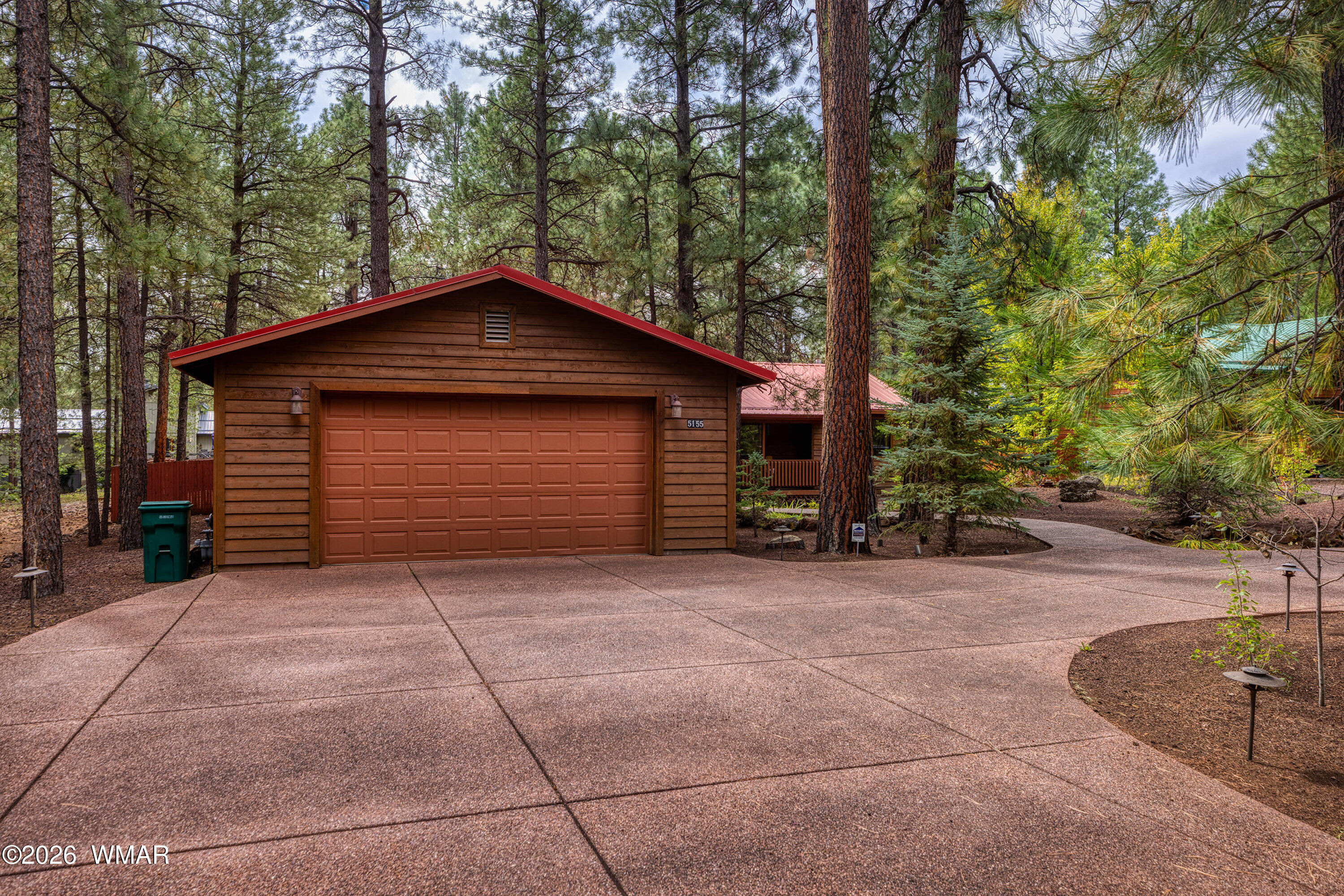 5155 Buck Springs Road Pinetop, AZ 85935 - Photo 2 of 37 a front view of a house with a yard and garage