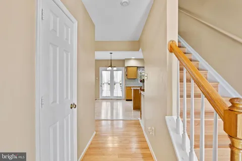 a view of a hallway with wooden floor and staircase