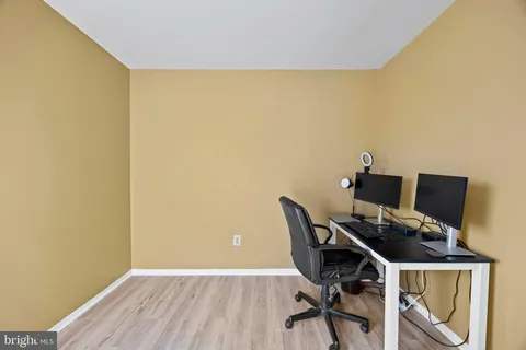 a bathroom with a granite countertop sink a toilet and a mirror
