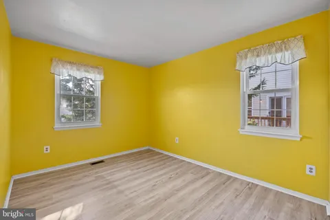 a view of a room with gym equipment and a large window