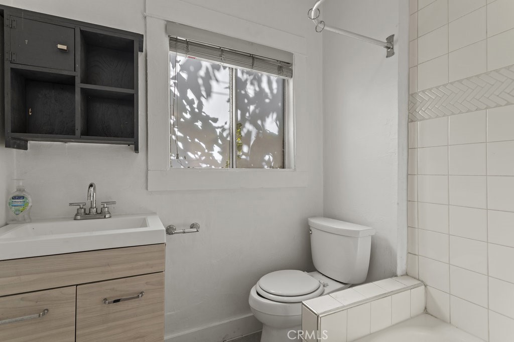 224 West 14th Street Long Beach, CA 90813 - Photo 21 of 28 a bathroom with a toilet sink and mirror