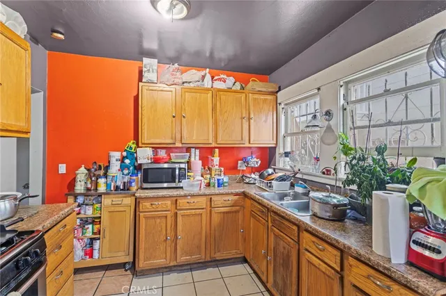a kitchen with a sink stove and cabinets