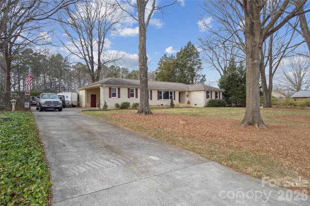a front view of a house with a yard and trees
