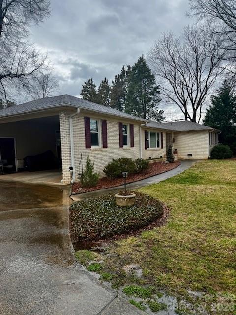a view of a house with a yard and potted plants