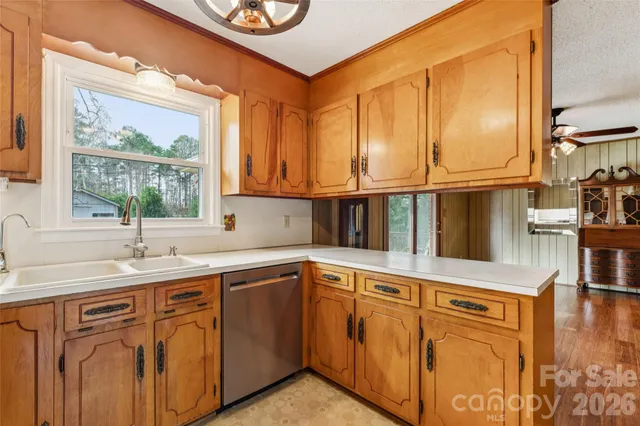 a kitchen with stainless steel appliances granite countertop a sink a stove and cabinets
