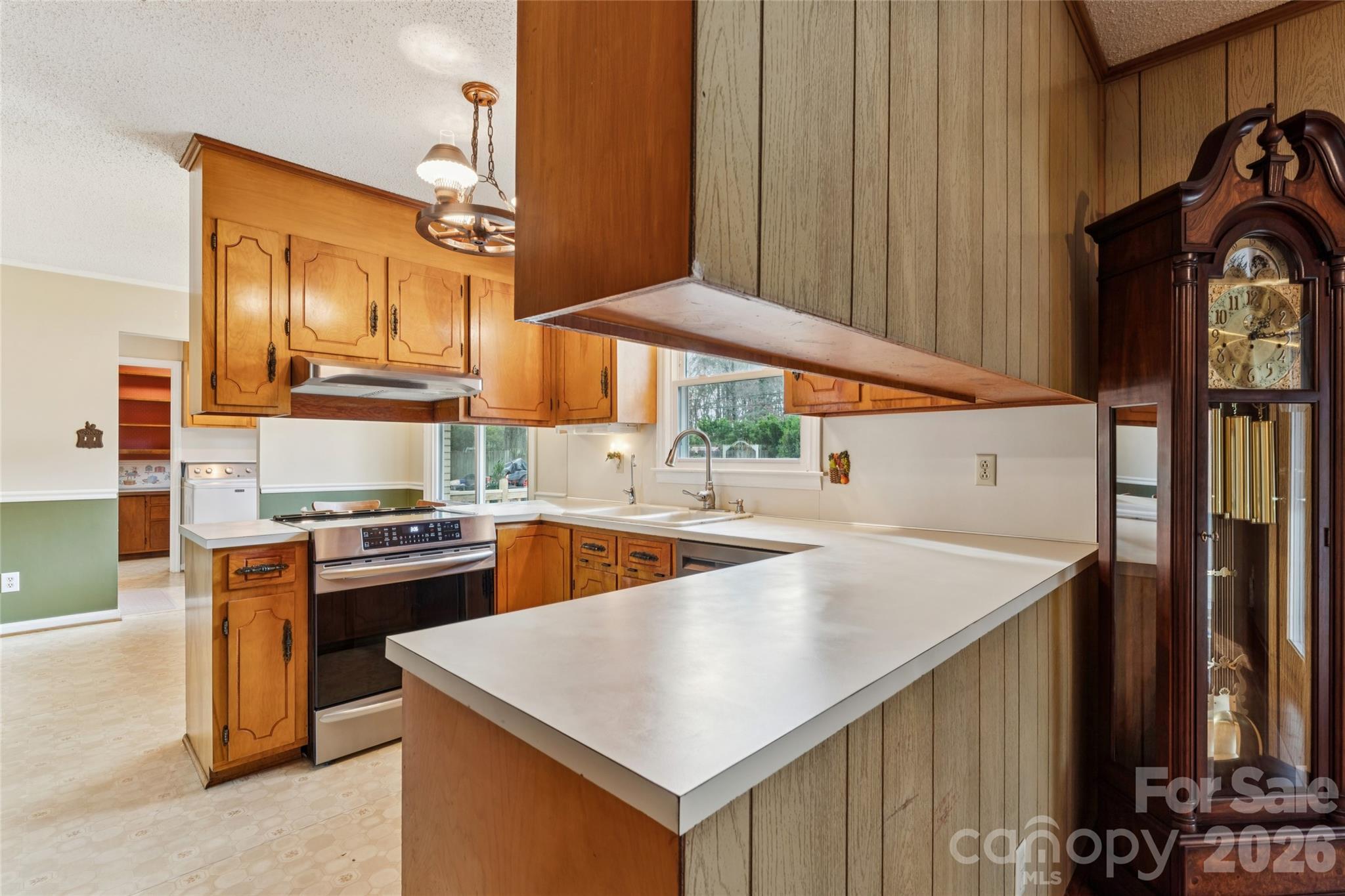 14409 Springwater Drive Matthews, NC 28105 - Photo 24 of 27 a kitchen with stainless steel appliances granite countertop a sink a stove and a refrigerator
