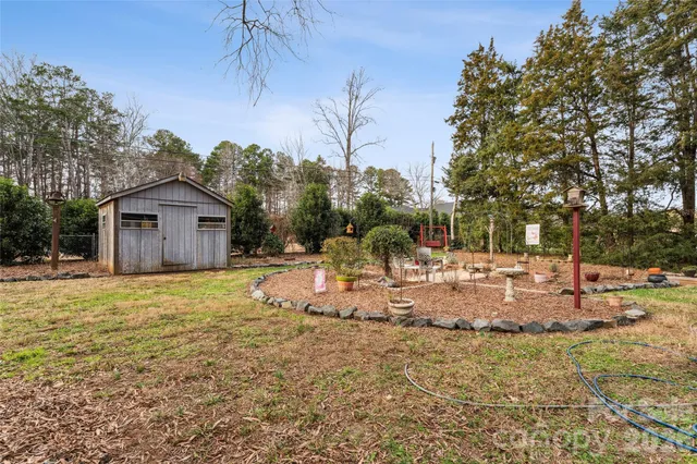 a view of a house with backyard and trees