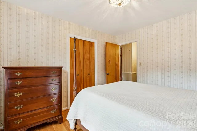 a bedroom with a bed and a dresser