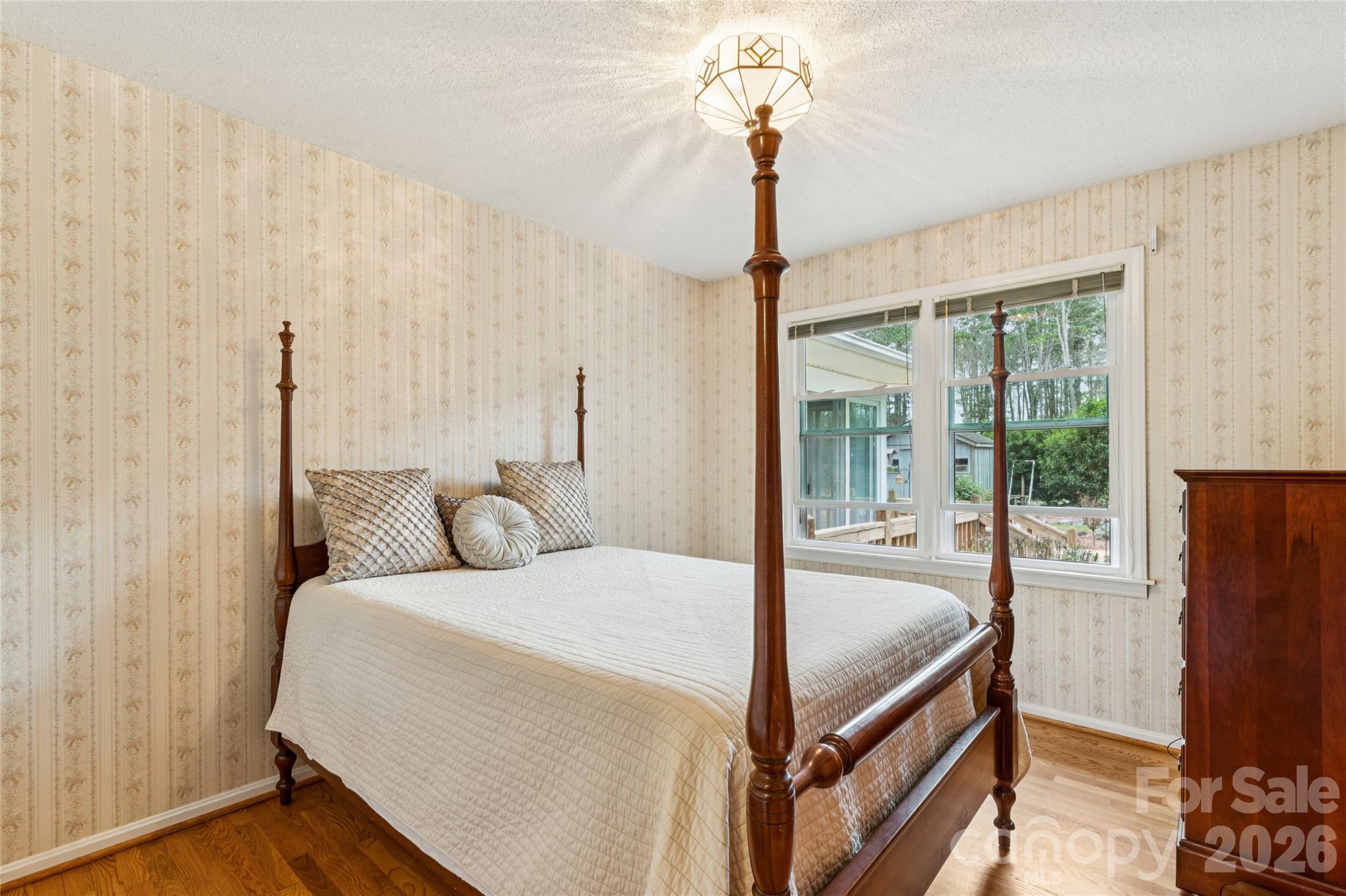 14409 Springwater Drive Matthews, NC 28105 - Photo 9 of 27 a bedroom with a bed and large window