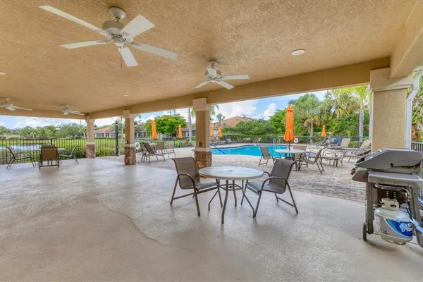 a view of a patio with a table chairs and a backyard