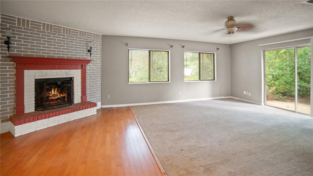 135 East Citrus Street Altamonte Springs, FL 32701 - Photo 13 of 33 a view of empty room with wooden floor and a fireplace