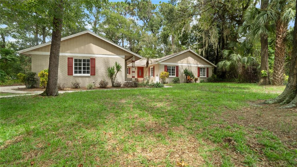 135 East Citrus Street Altamonte Springs, FL 32701 - Photo 2 of 33 a front view of a house with a yard and trees