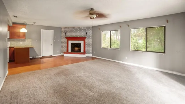 a front view of a house with a yard and green space