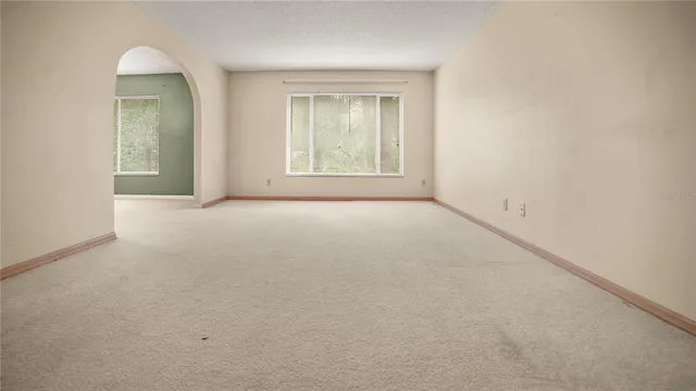 an empty room with a kitchen
