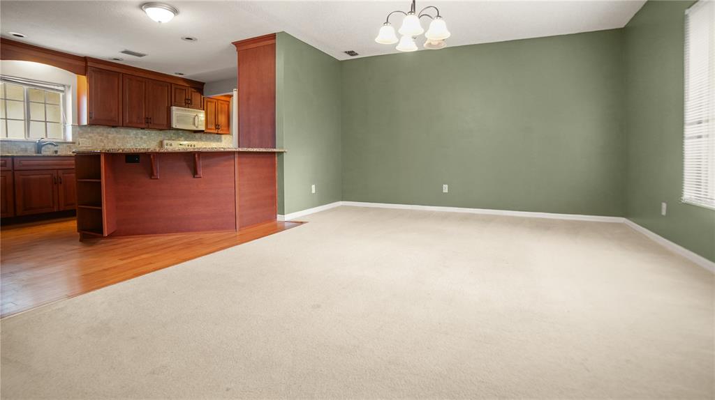 135 East Citrus Street Altamonte Springs, FL 32701 - Photo 6 of 33 an empty room with a kitchen