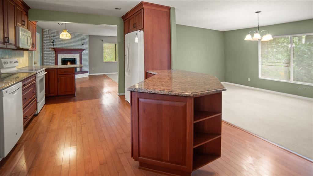 135 East Citrus Street Altamonte Springs, FL 32701 - Photo 7 of 33 a kitchen with a wooden floor and a view of living room