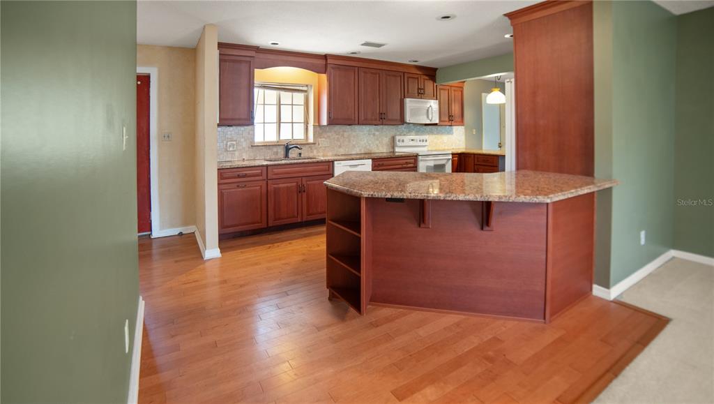 135 East Citrus Street Altamonte Springs, FL 32701 - Photo 9 of 33 a kitchen with stainless steel appliances granite countertop a sink and a stove