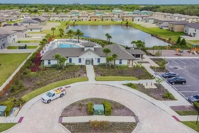 an aerial view of a house with a lake view