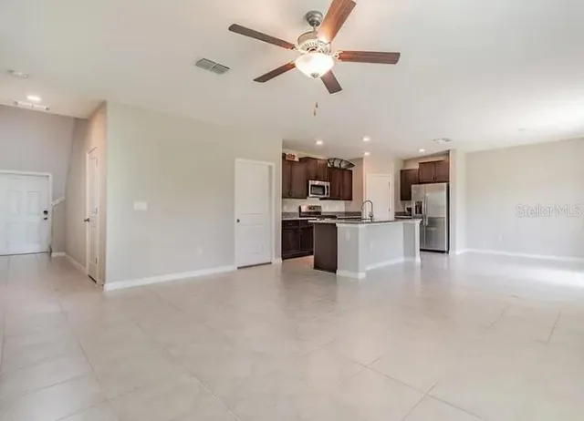 a view of a kitchen with a sink and stainless steel appliances