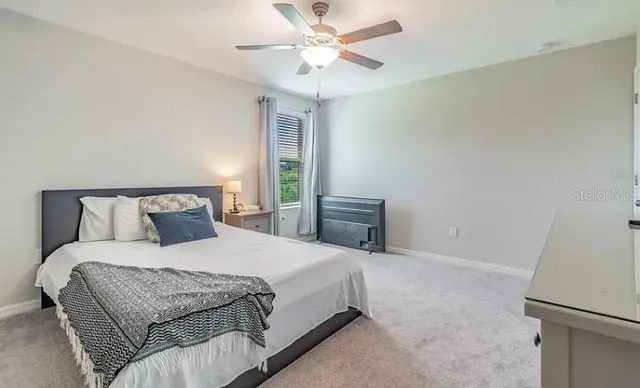 a bedroom with a bed and a chandelier