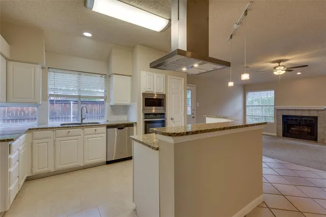 a kitchen with stainless steel appliances granite countertop a stove and a sink