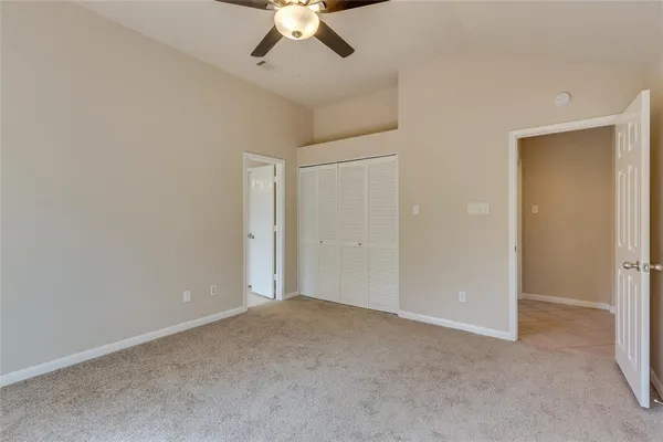 a view of a livingroom with a ceiling fan and window