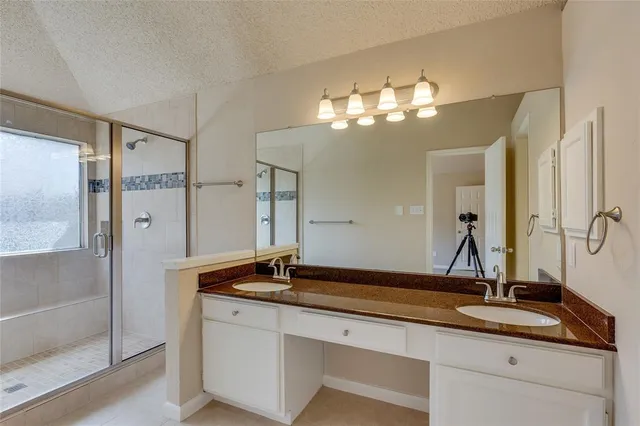 a bathroom with a sink double vanity and a mirror