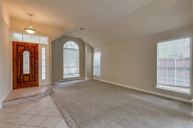 a view of a room with large windows and a chandelier