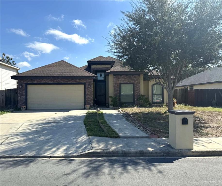 4014 Magdalena Street Mission, TX 78573 - Photo 2 of 9 a front view of a house with yard garage and brick tree