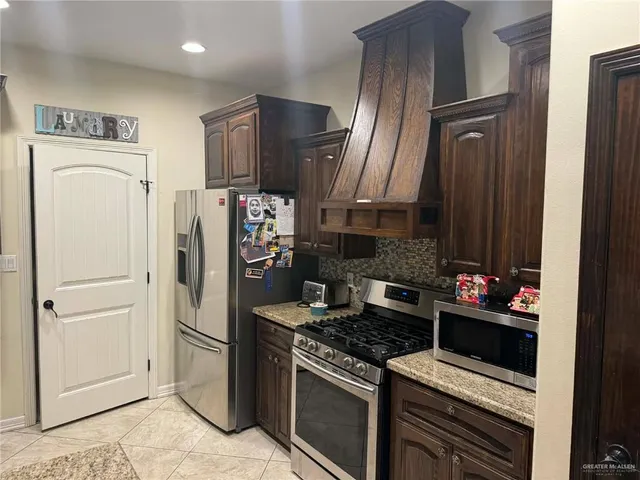 a kitchen with stainless steel appliances a refrigerator stove and sink