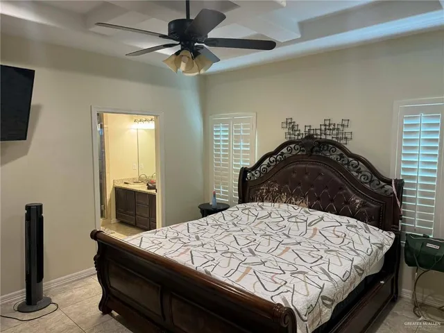 a bedroom with a bed and a mirror