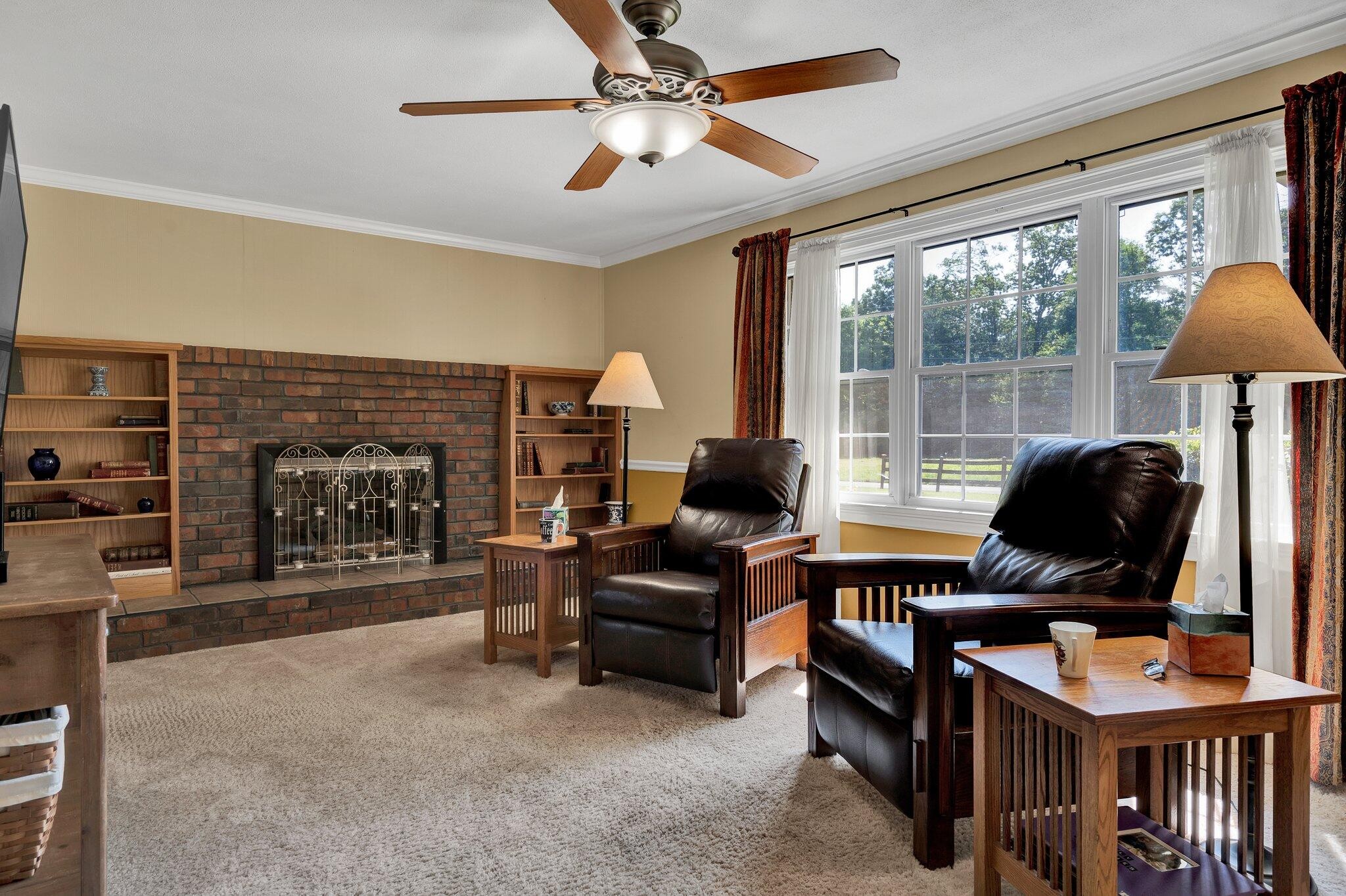 470 Armstrong Road Southeast Cleveland, TN 37323 - Photo 11 of 57 a living room with furniture a ceiling fan and a fireplace