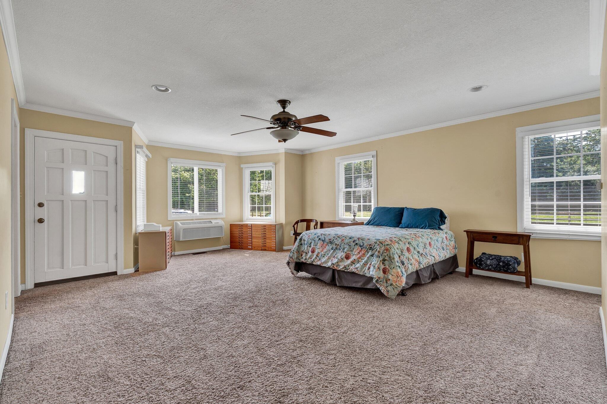 470 Armstrong Road Southeast Cleveland, TN 37323 - Photo 23 of 57 a spacious bedroom with a large bed and a chandelier