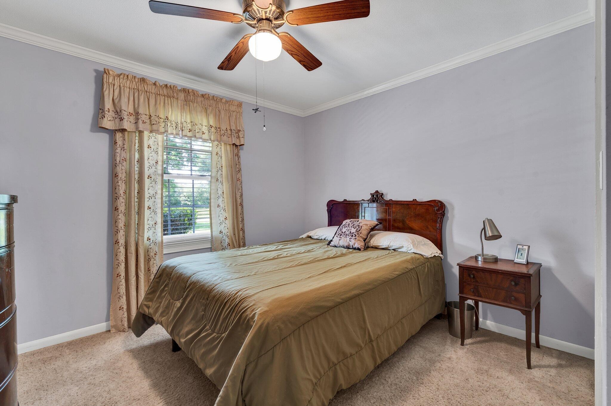 470 Armstrong Road Southeast Cleveland, TN 37323 - Photo 30 of 57 a bedroom with a bed and a chandelier