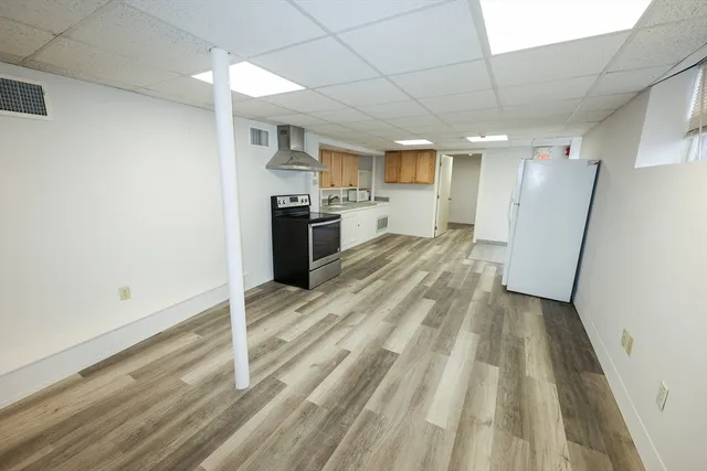 a view of a kitchen with a sink and cabinets