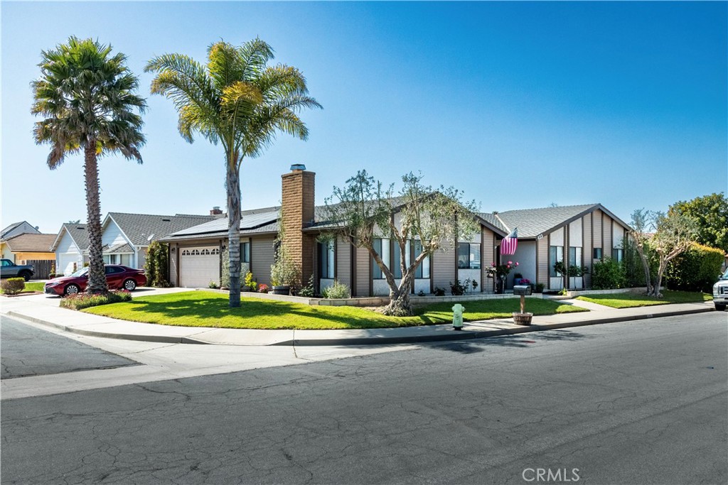 423 Garnet Way Santa Maria, CA 93454 - Photo 1 of 1 a front view of a building with small garden and trees