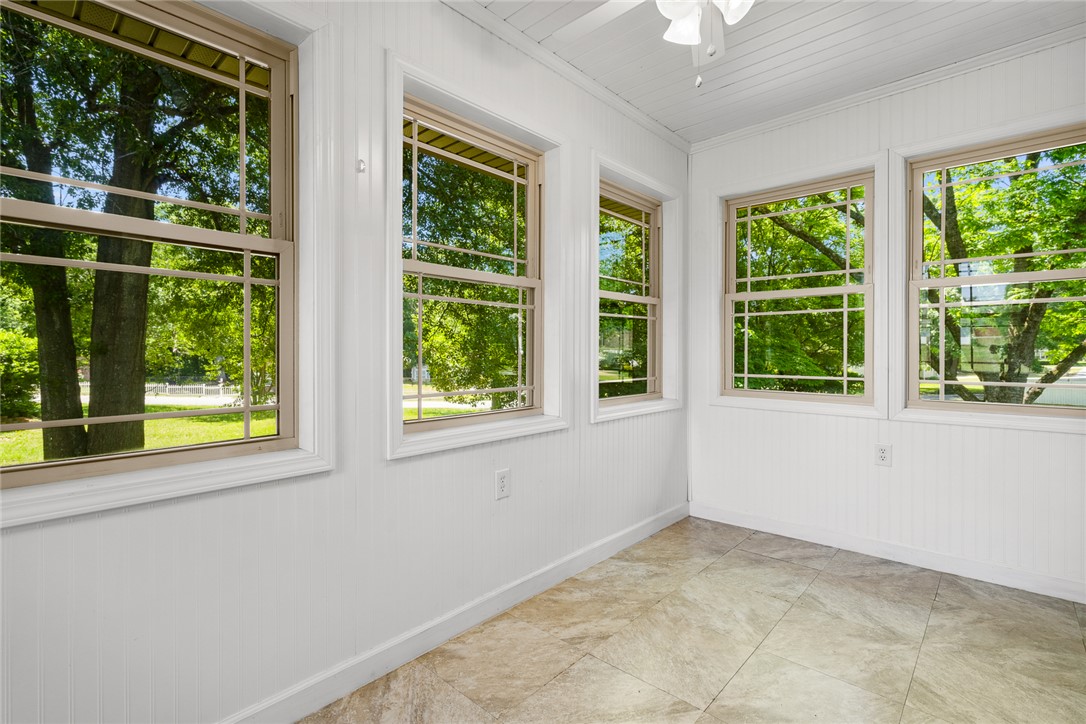 1509 869 Anderson, SC 29621 - Photo 31 of 45 A well-lit sunroom with ample windows overlooks lush, verdant trees.