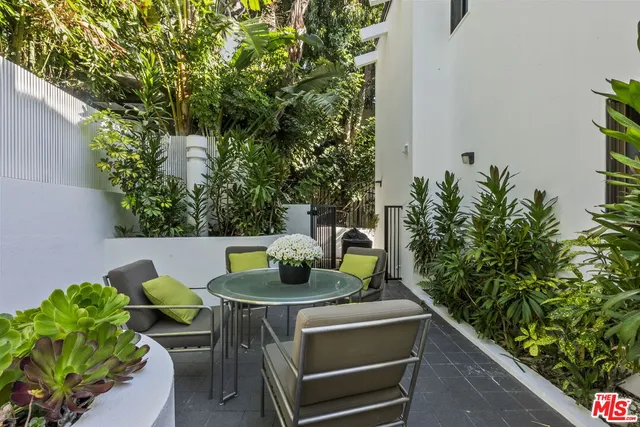 a view of a porch with furniture and a fire pit