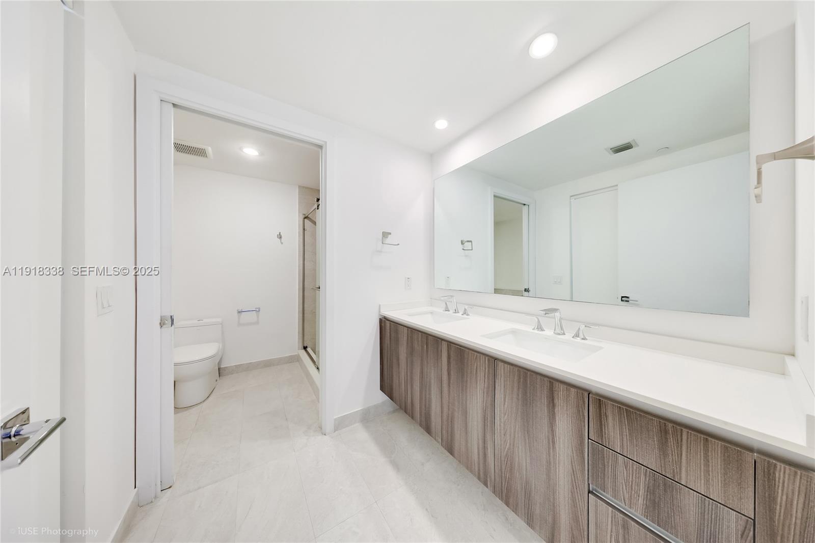 488 Northeast 18th Street, Unit 2304 Miami, FL 33132 - Photo 11 of 41 a spacious bathroom with a double vanity sink toilet and shower